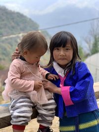 Bhutanese kids- elder sister caring the younger.