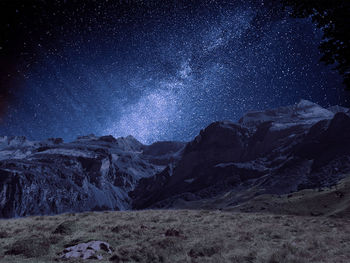 Scenic view of mountains against sky at night