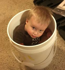 Close-up portrait of baby girl in bowl