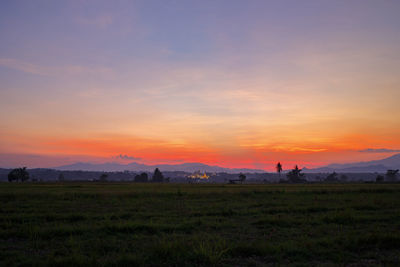 Scenic view of field against sky during sunset