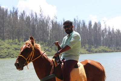 Young man riding horse sign of summer