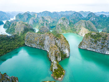 High angle view of rocks in sea against sky