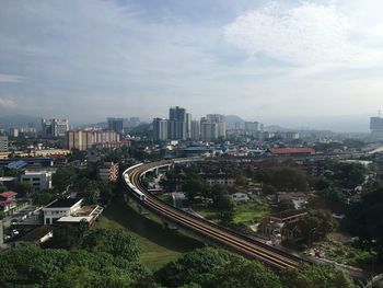 High angle view of street amidst buildings against sky