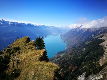 High angle view of trees and mountains against blue sky