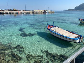 High angle view of sailboats moored on sea against sky