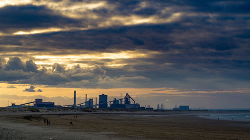 View of beach against cloudy sky