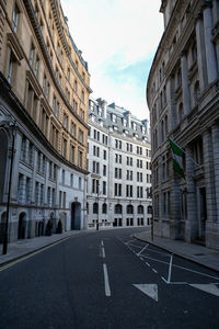 Road amidst buildings against sky in city