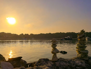 Scenic view of lake against sky during sunset