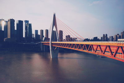 Bridge over river with buildings in background