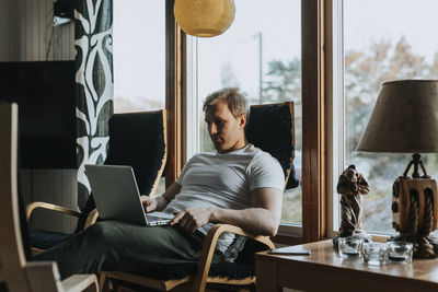 Man on chair using laptop