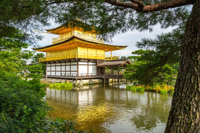 Kinkaku-ji temple in lake amidst trees