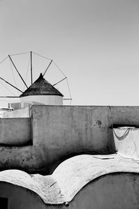 Low angle view of old windmill building against clear sky