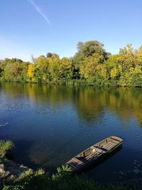 Scenic view of lake by trees against sky