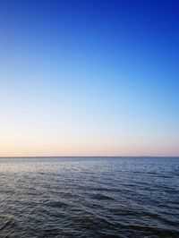 Scenic view of sea against clear sky during sunset