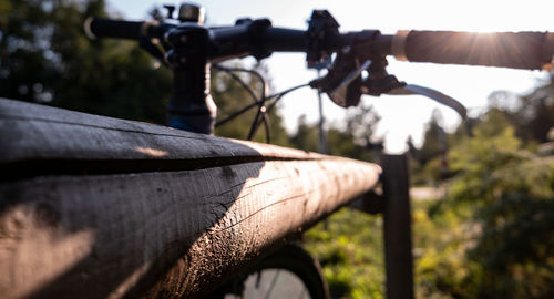 Close-up of bicycle against sky on sunny day
