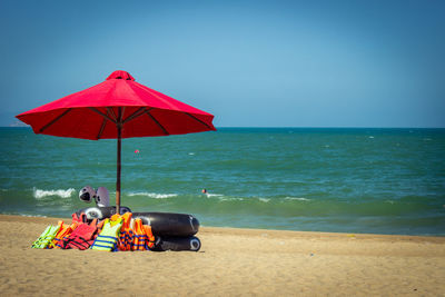 Umbrellas on beach against clear sky