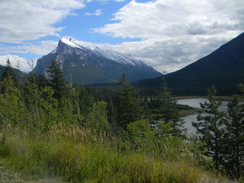 Scenic view of mountains against cloudy sky