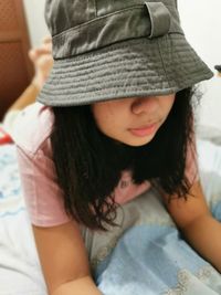 Close-up of girl wearing hat at home