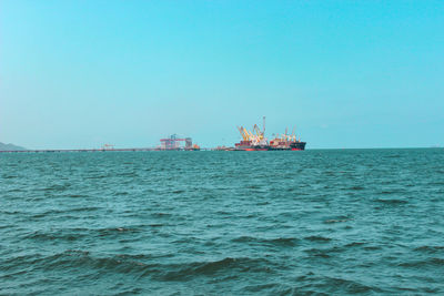 Scenic view of sea against clear blue sky