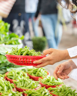 Midsection of man eating food at market