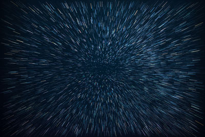 Firework display against sky at night