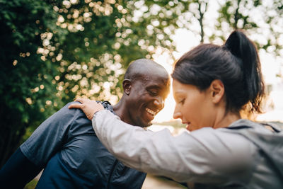 Portrait of friends with man and tree