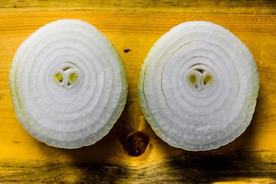 Close-up of onion rings on wooden table