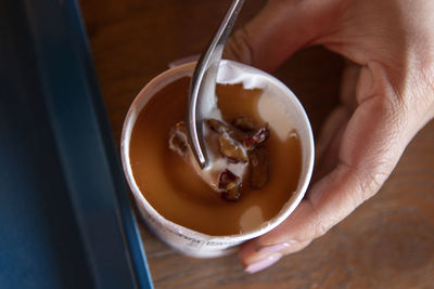 Cropped hand holding coffee