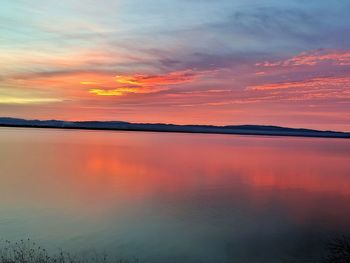 Scenic view of lake against romantic sky at sunset