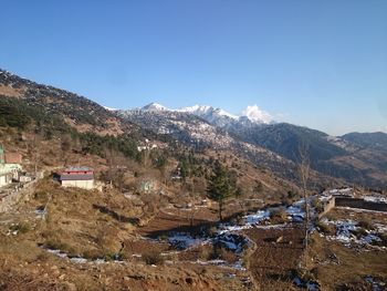 Scenic view of mountains against clear blue sky