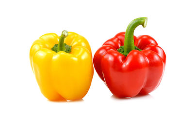 Close-up of red bell peppers against white background