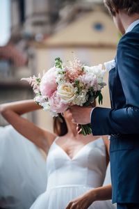 Midsection of woman holding flower bouquet