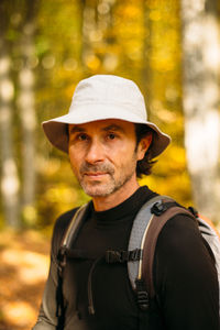 Close-up portrait of tourist man in panama hat. colorful bokeh