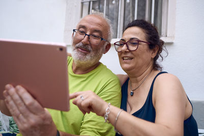 Portrait of smiling young woman using mobile phone