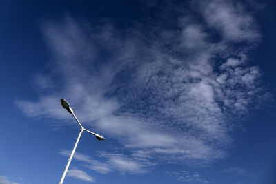 Low angle view of windmill against blue sky