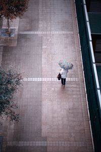 High angle view of woman walking on footpath