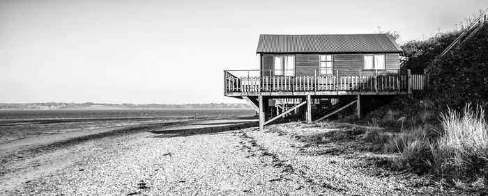 Old abandoned truck on field against clear sky