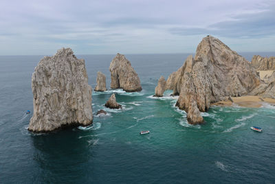 Panoramic view of rocks in sea against sky