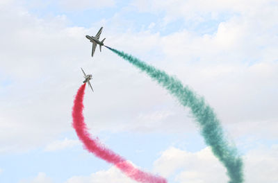 Low angle view of airplane flying against sky