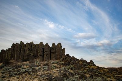 Low angle view of rock formation against sky