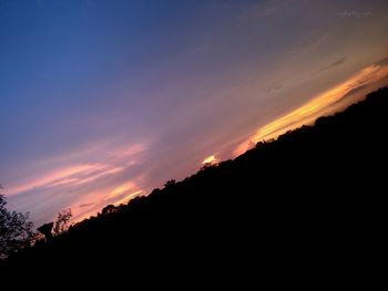 Scenic view of silhouette trees against sky at sunset