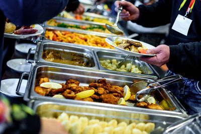 Cropped image of hand taking food