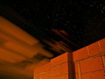 Low angle view of building against stars in sky at night