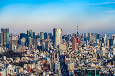 Aerial view of modern buildings in city against sky