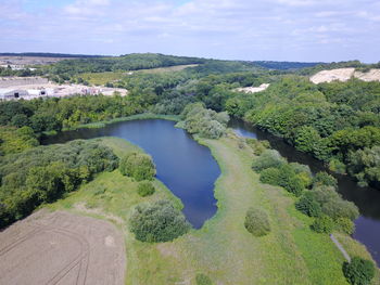 High angle view of river amidst plants against sky