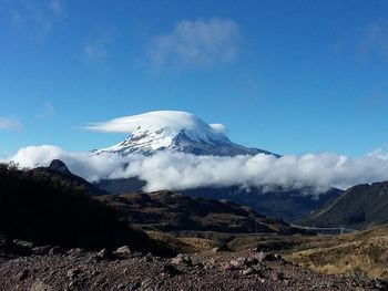 Scenic view of snowcapped mountains against blue sky