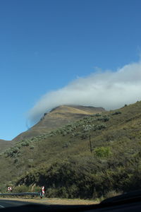 Scenic view of mountains against blue sky