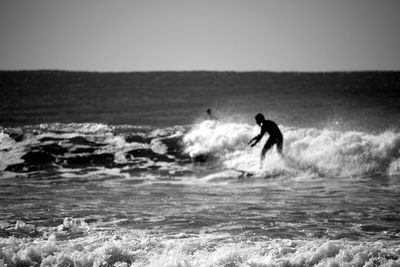 People surfing in sea