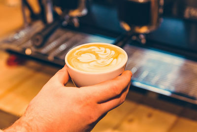 Cropped hand holding coffee