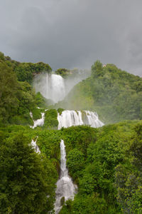 Scenic view of waterfall against sky